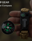 Hand holding a compass with a rope attachment, branded 'OP GEAR'.